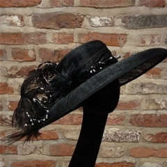 classic downbrim with curled ostrich feathers and intricate beadwork.