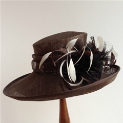 my hat side swept brim with folded sinamay trimming and ivory coque feathers.