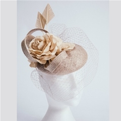 Almond parasisal beret with silk rose, arrowhead feathers and veiling. Handmade by our own milliners, using traditional techniques. Demure and sophisticated. Can be made to order in your own colours. 
