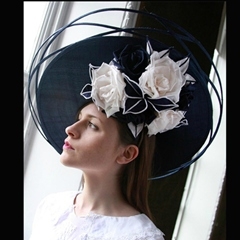 classic navy blue guibert tilted disc with intricately woven outer brim, trimmed with ivory hand crafted silk roses. beautiful.