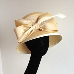decadent silk hat finished with bow detail.