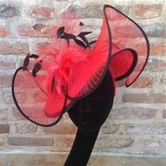 A sinamay coolie disc with a pleated crin wave, topped with a feather mount, on a satin covered alice band very striking!
