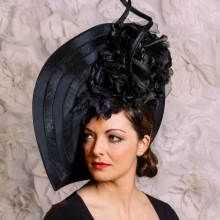 new from guibert millinery. black wave disc with a twist