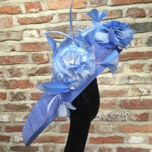 cornflower blue tilted sinamay disc with two tone ivory and pale blue  feather flowers, veiling and pearl detail.